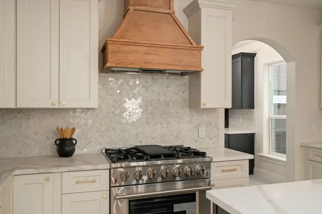 a kitchen with a sink a stove a refrigerator and island