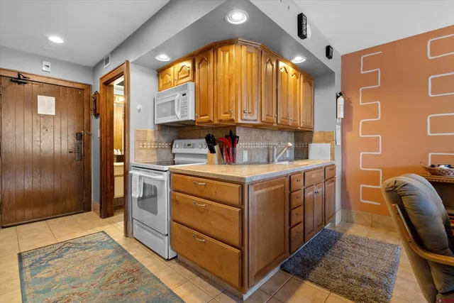 a kitchen with a sink cabinets and a window