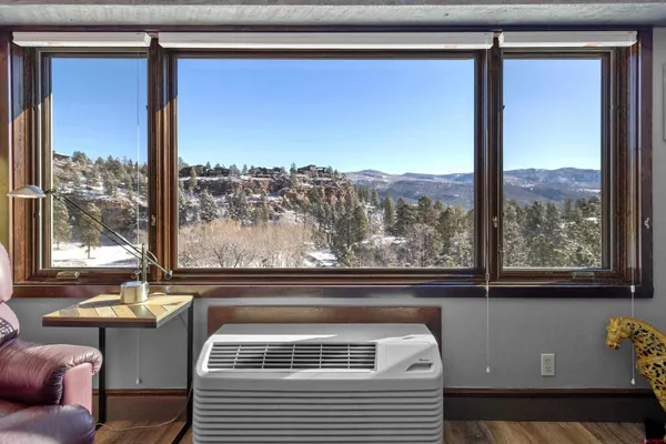 a view of a couch sitting in front of a window