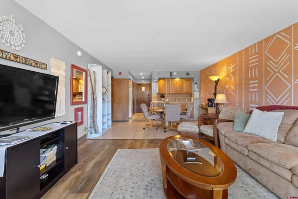 a living room with furniture a flat screen tv and a fireplace