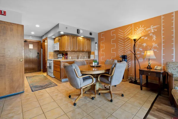 a work room with furniture and a floor to ceiling window