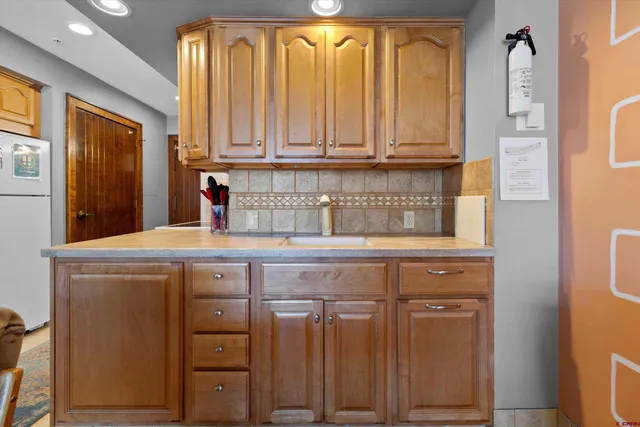 a kitchen with stainless steel appliances a sink and cabinets