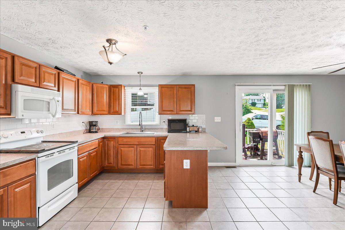 107 Britton Drive Rising Sun, MD 21911 - Photo 11 of 30 a kitchen with a stove a sink and a refrigerator