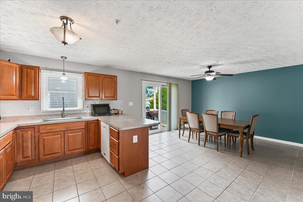 107 Britton Drive Rising Sun, MD 21911 - Photo 12 of 30 a kitchen with a table chairs and microwave