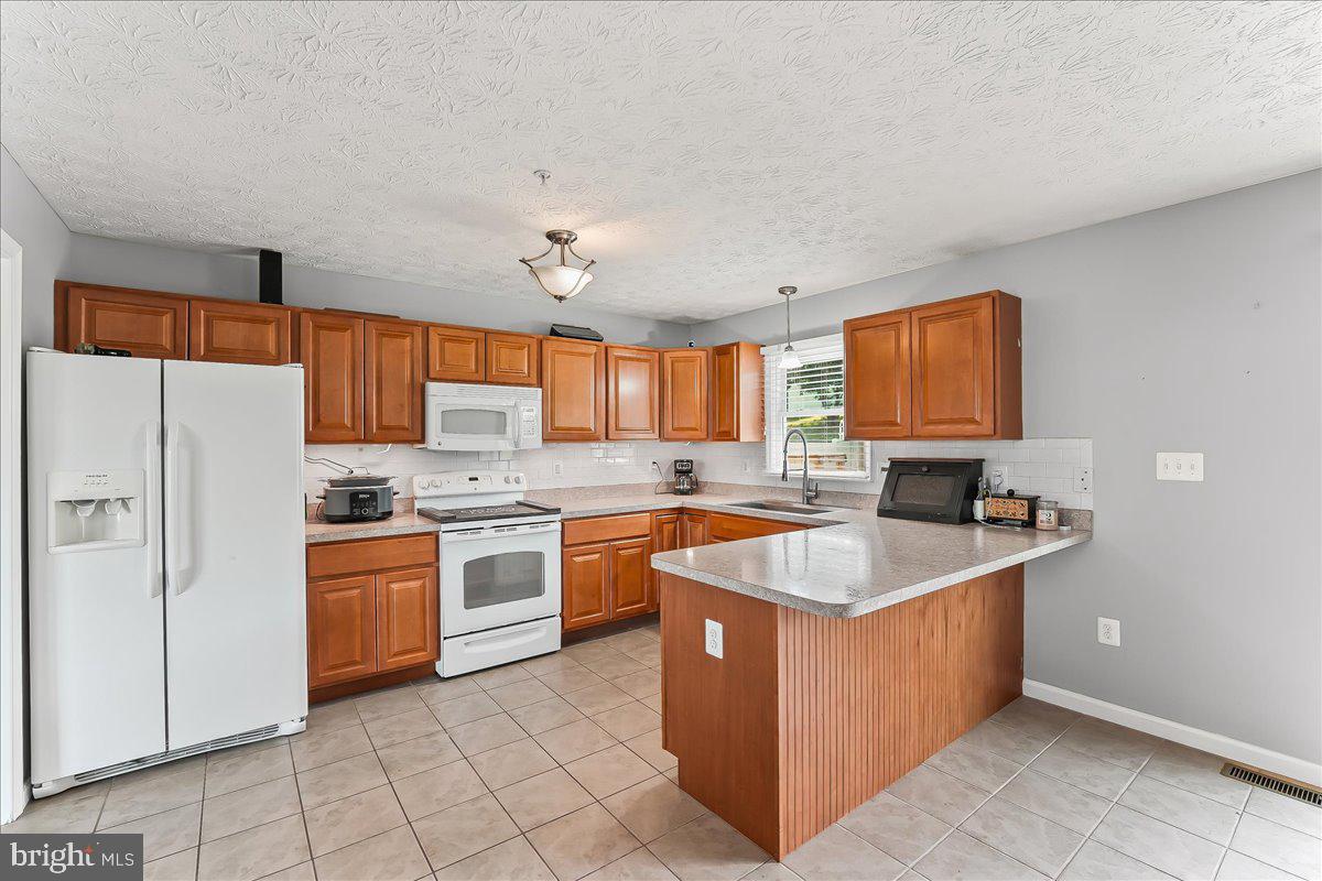 107 Britton Drive Rising Sun, MD 21911 - Photo 13 of 30 a kitchen with stainless steel appliances granite countertop a sink counter space cabinets and a window