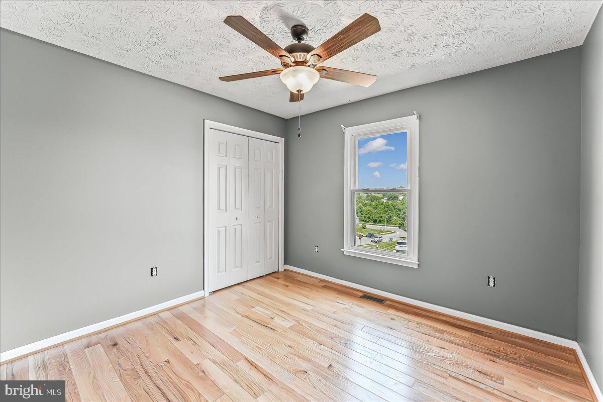 107 Britton Drive Rising Sun, MD 21911 - Photo 16 of 30 an empty room with window and ceiling fan