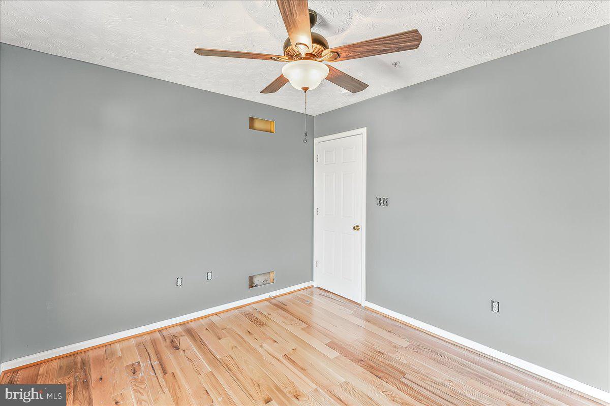 107 Britton Drive Rising Sun, MD 21911 - Photo 17 of 30 an empty room with fan and a chandelier fan