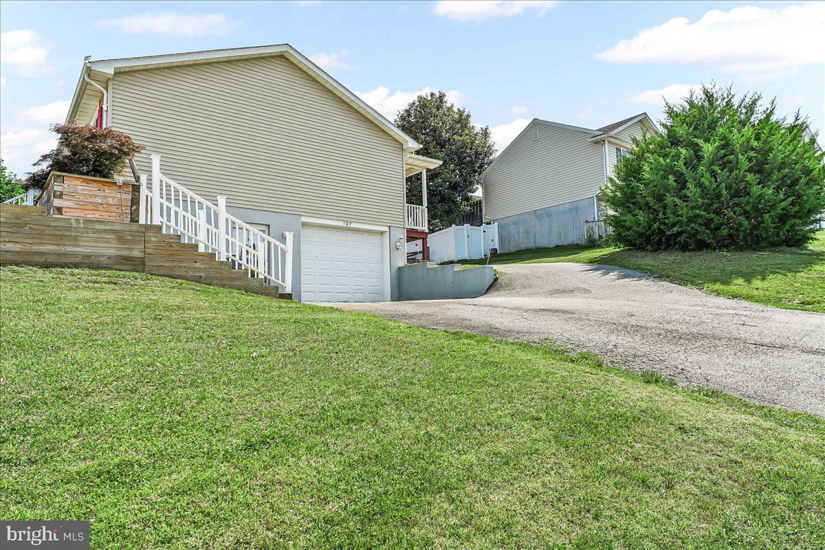 107 Britton Drive Rising Sun, MD 21911 - Photo 27 of 30 a backyard of a house with table and chairs plants and large tree