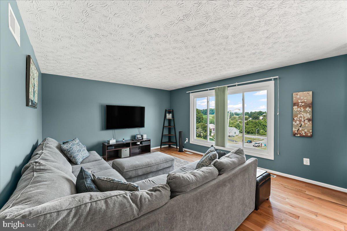107 Britton Drive Rising Sun, MD 21911 - Photo 7 of 30 a living room with furniture and a flat screen tv