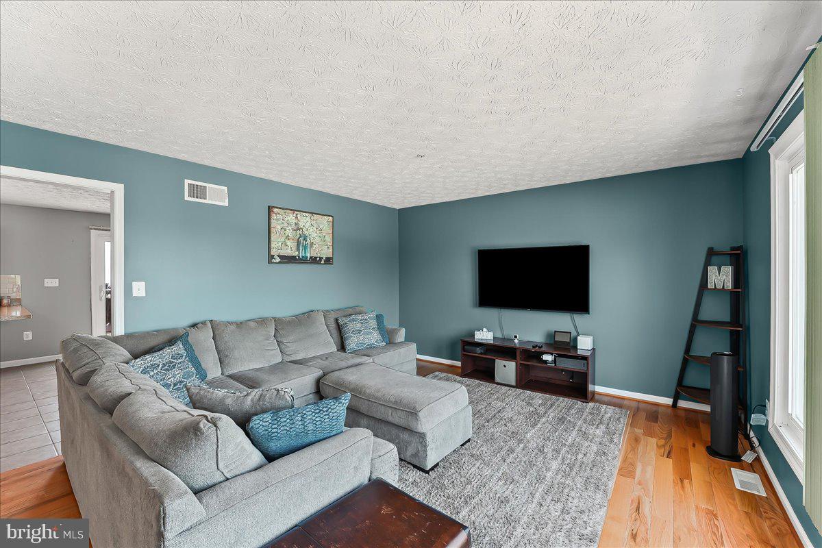 107 Britton Drive Rising Sun, MD 21911 - Photo 9 of 30 a living room with furniture and a flat screen tv