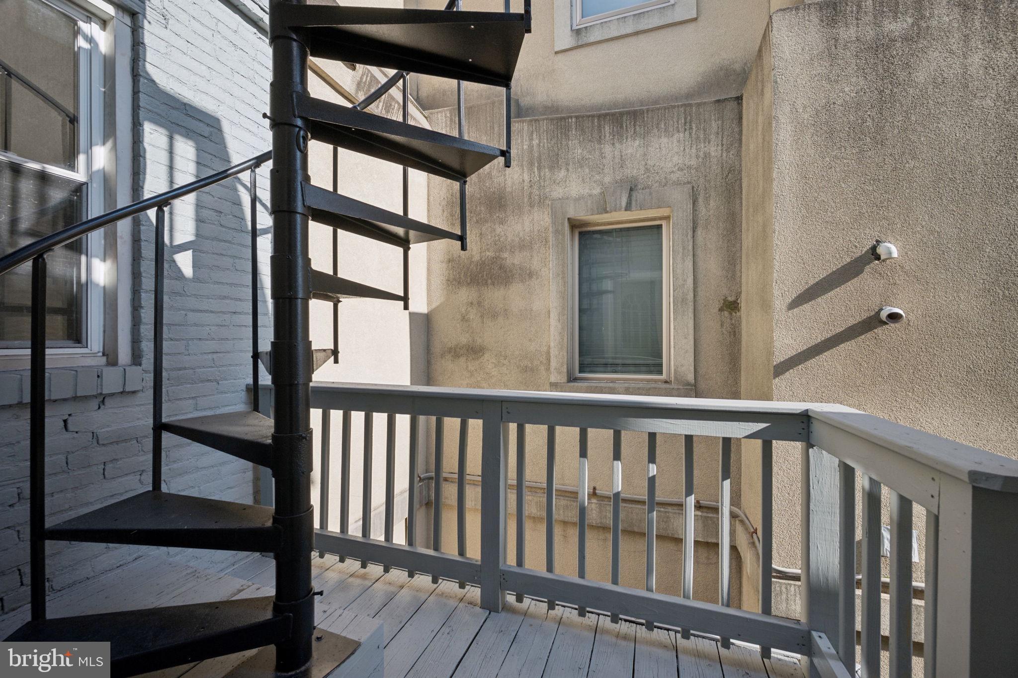 1108 South Clinton Street Baltimore, MD 21224 - Photo 47 of 66 Charming spiral staircase to a balcony.
