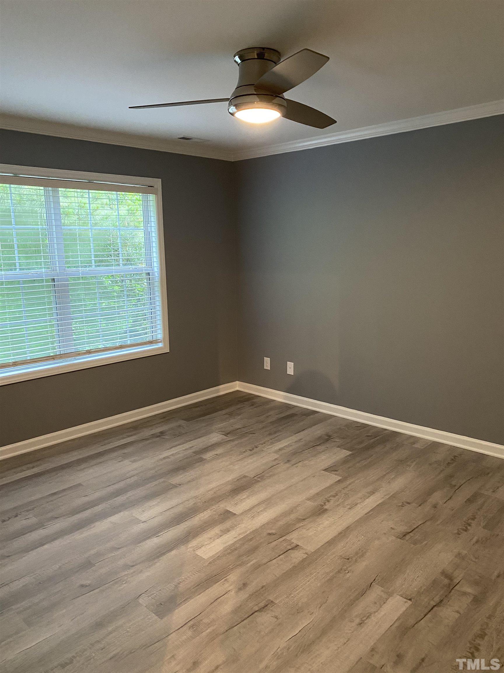 4422 Wellington Ridge Loop, Unit 4422 Cary, NC 27518 - Photo 11 of 40 an empty room with wooden floor and windows