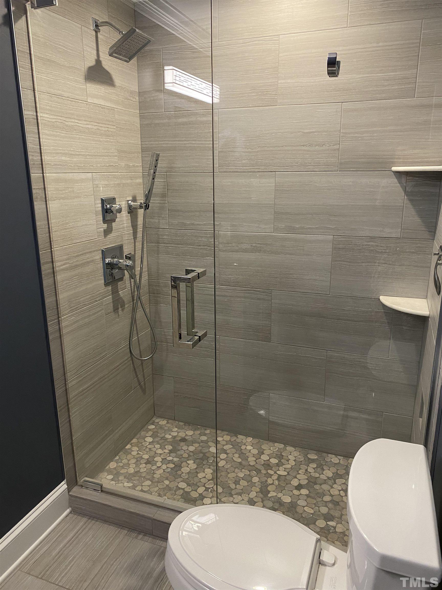 4422 Wellington Ridge Loop, Unit 4422 Cary, NC 27518 - Photo 21 of 40 a bathroom with a toilet and a shower