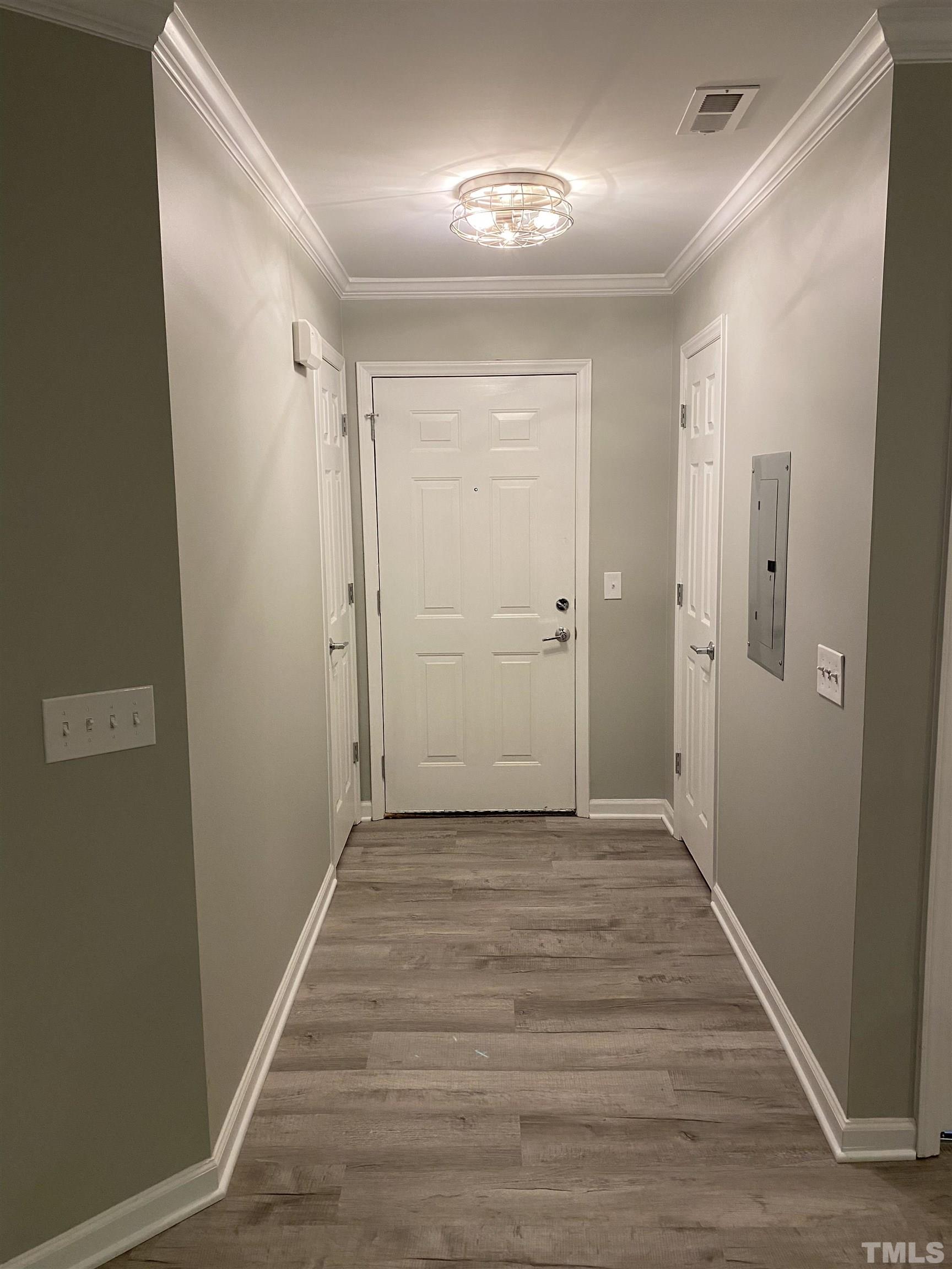 4422 Wellington Ridge Loop, Unit 4422 Cary, NC 27518 - Photo 3 of 40 a view of a hallway with wooden floor