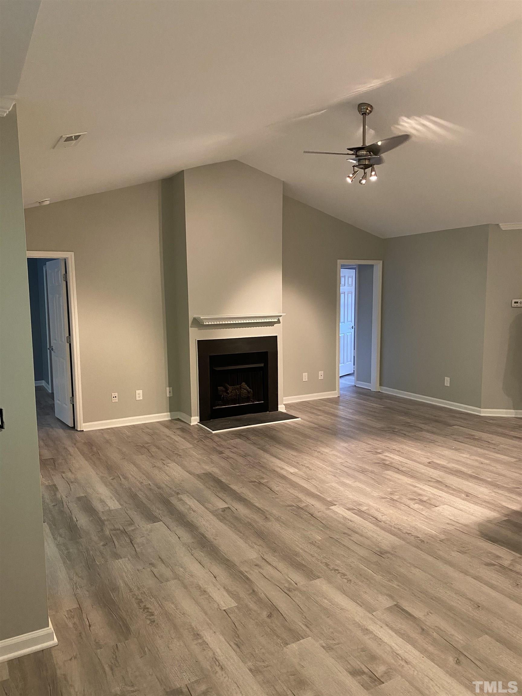 4422 Wellington Ridge Loop, Unit 4422 Cary, NC 27518 - Photo 4 of 40 a view of empty room with wooden floor and fan
