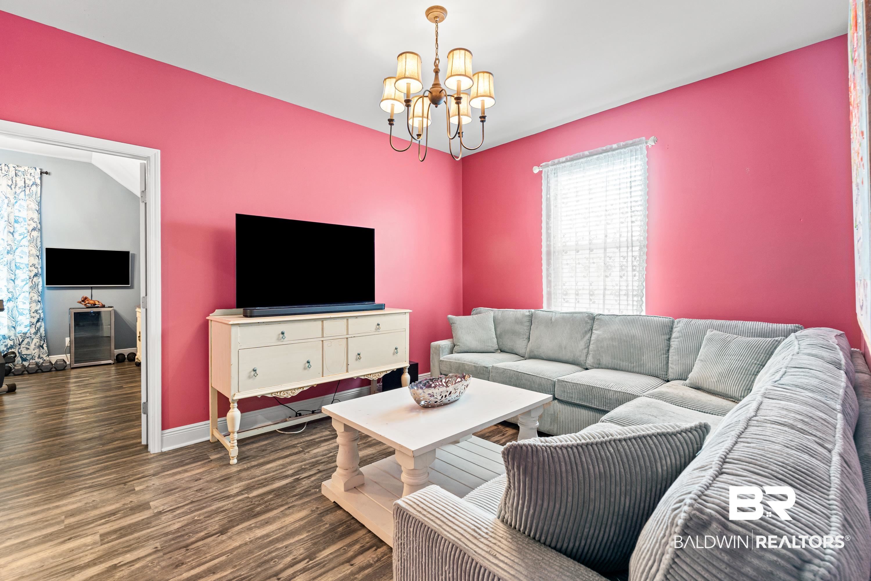1113 Yellow Daisy Lane Foley, AL 36535 - Photo 21 of 35 Living room with wood finished floors and a chandelier