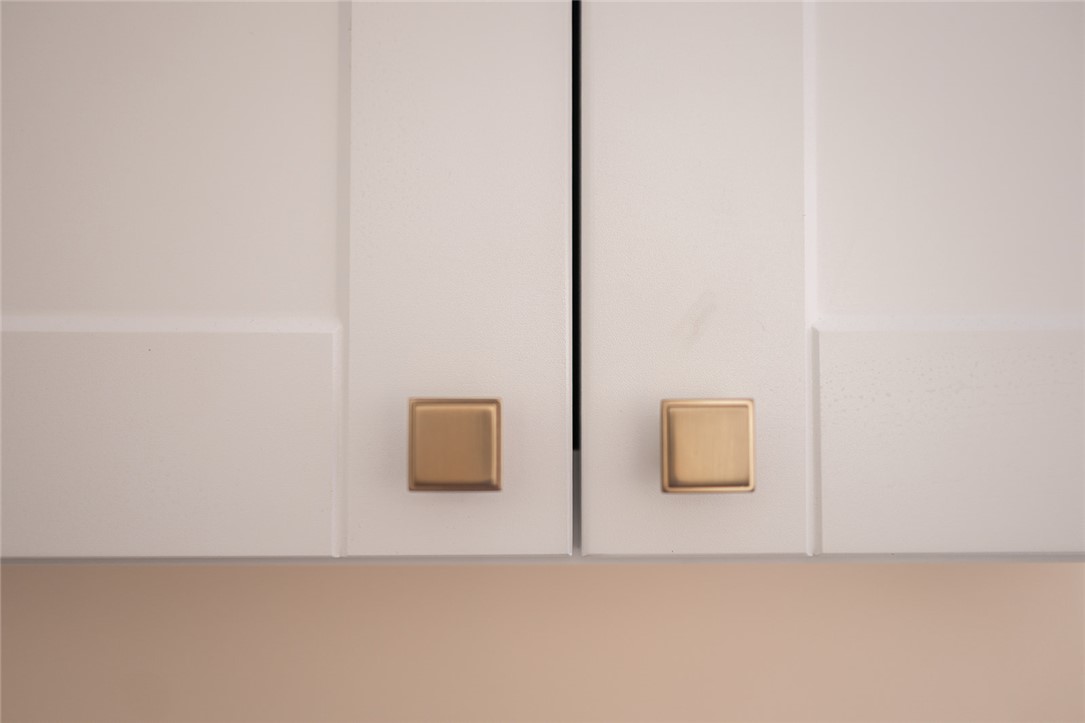 209 Cleveland Pike Road Westminster, SC 29693 - Photo 7 of 30 Clean lines and warm-toned hardware elevate these kitchen cabinets.