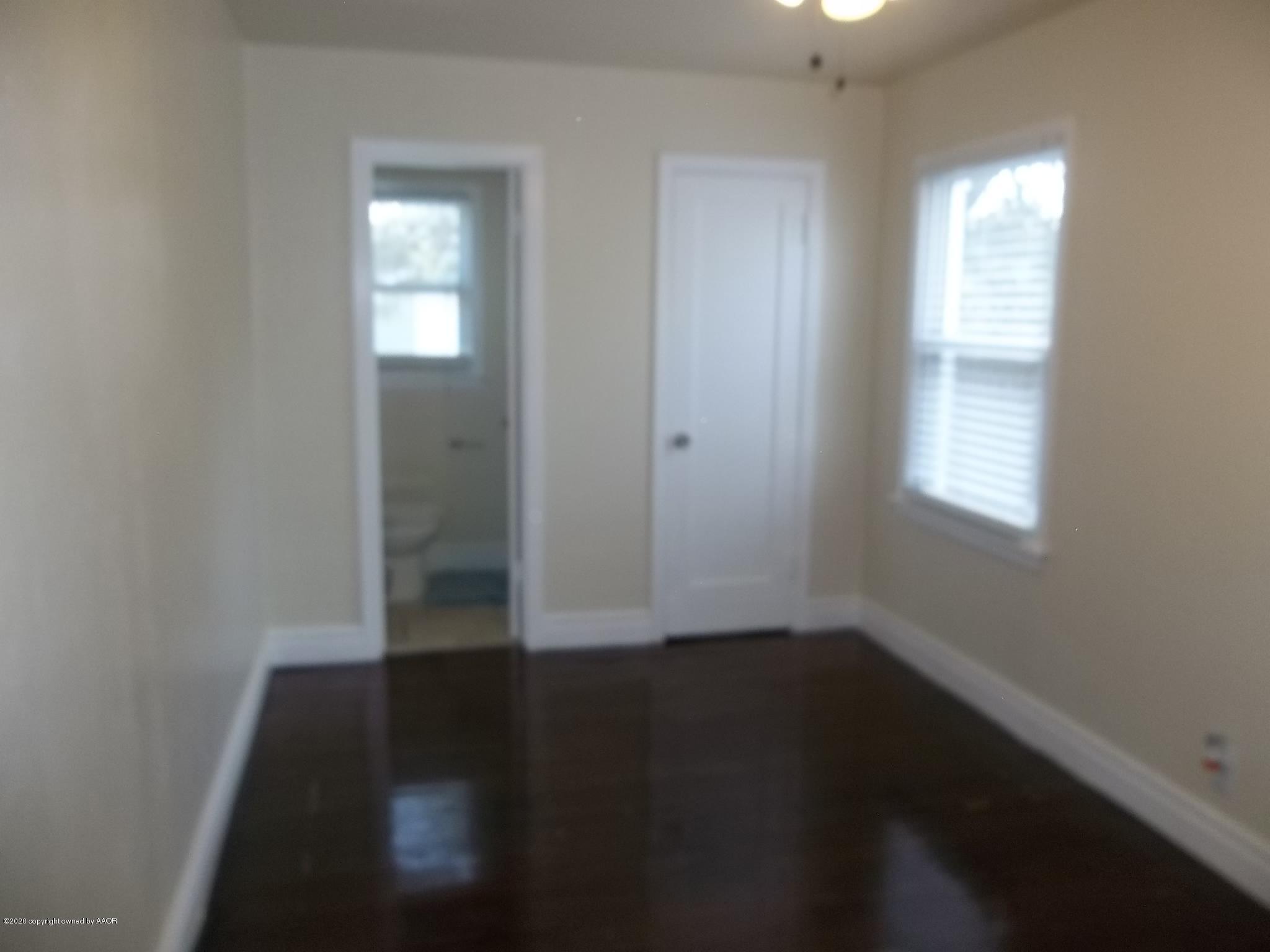 4117 South Tyler Street Amarillo, TX 79110 - Photo 16 of 18 an empty room with wooden floor and windows