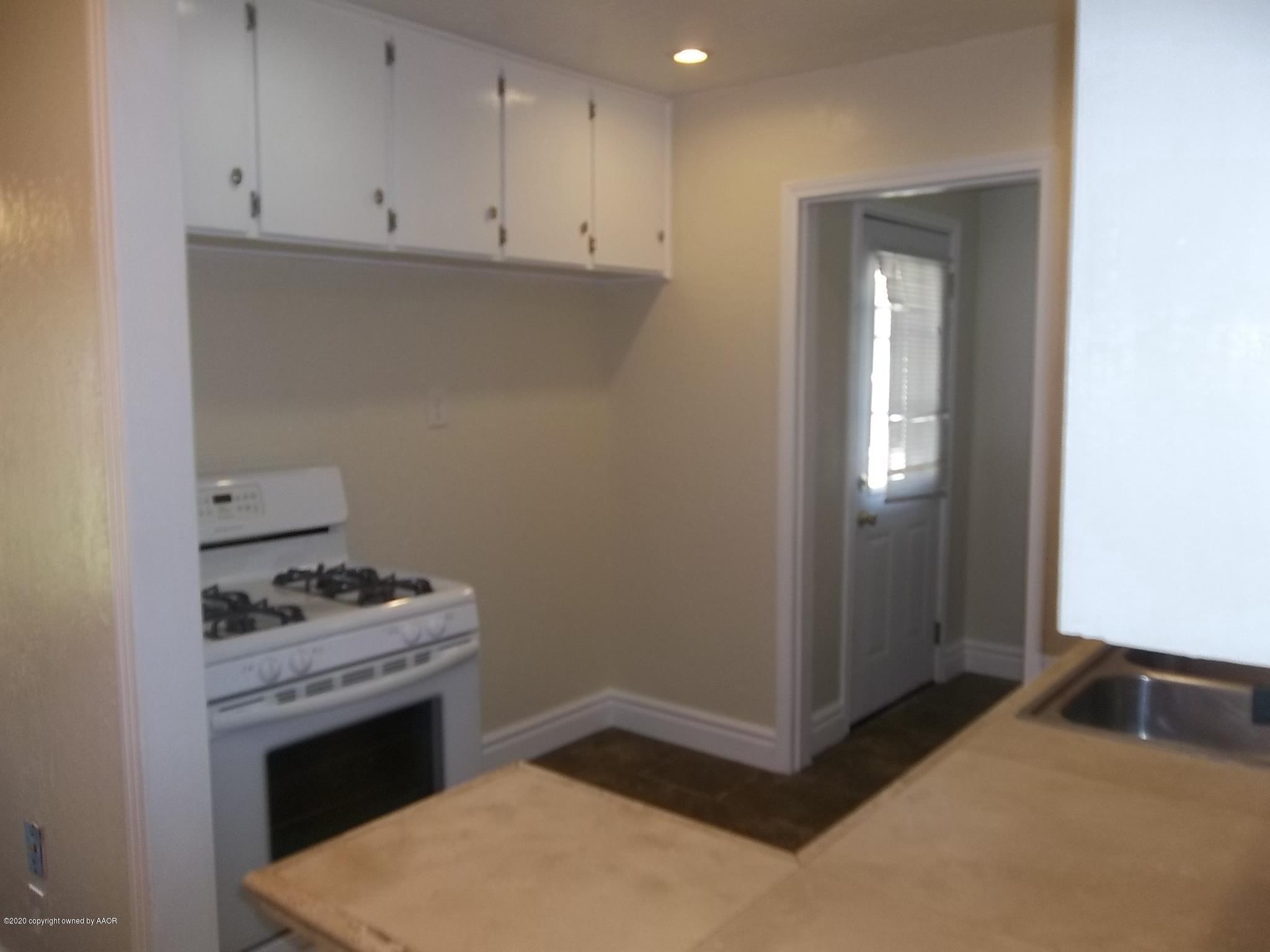 4117 South Tyler Street Amarillo, TX 79110 - Photo 7 of 18 a kitchen with a stove and a cabinet