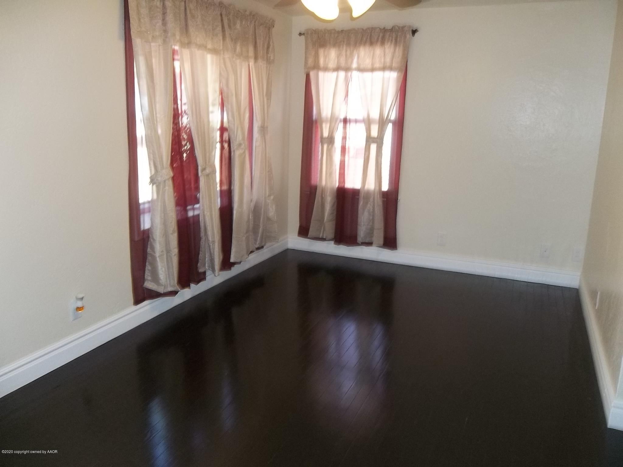 4117 South Tyler Street Amarillo, TX 79110 - Photo 10 of 18 a view of a room with wooden floor and windows