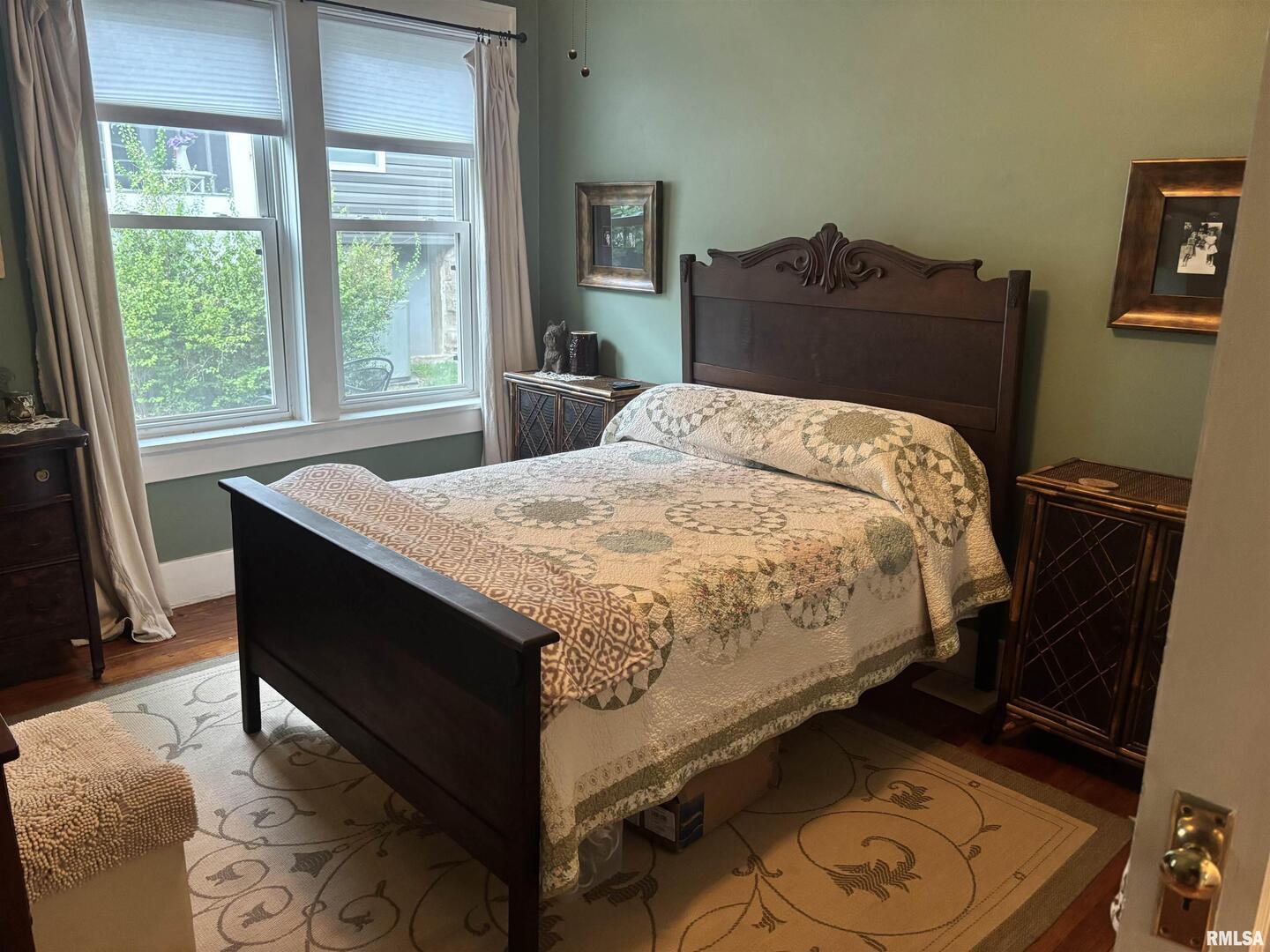 680 Stratton Street Chester, IL 62233 - Photo 13 of 22 a bed sitting in a bedroom next to a window