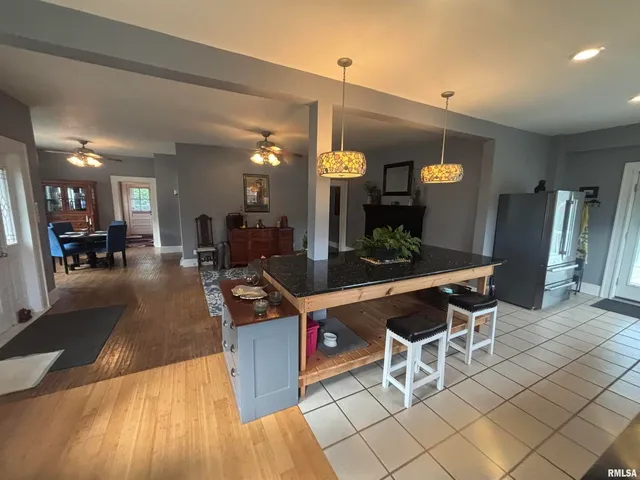 a kitchen with stainless steel appliances kitchen island granite countertop a sink and cabinets
