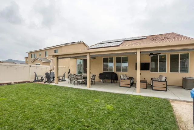 a view of a patio with table and chairs potted plants with wooden floor