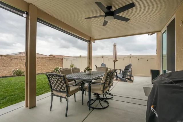 a bed room with a bed and a ceiling fan