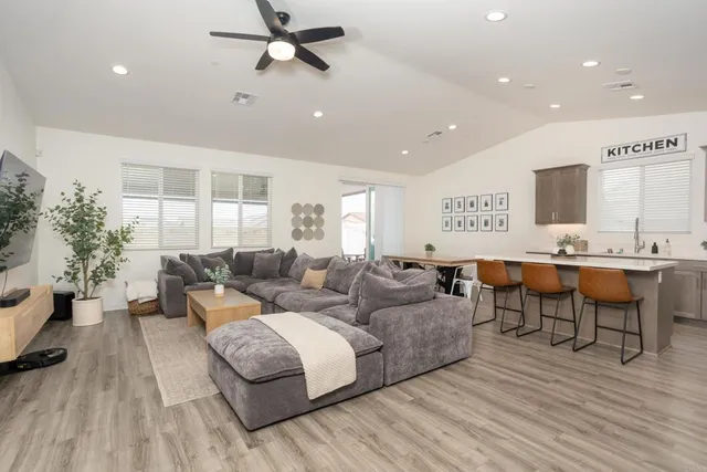 a living room with furniture and a wooden floor