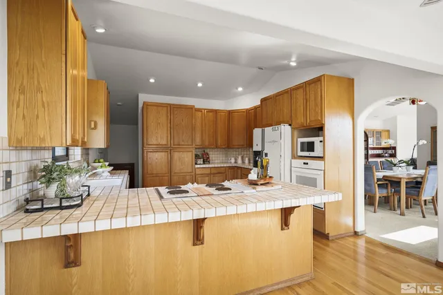 a large kitchen with a sink and cabinets