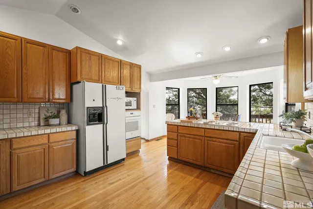 a view of a balcony with wooden floor and fence