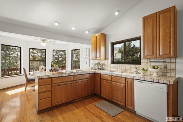 a view of deck with furniture and trees around