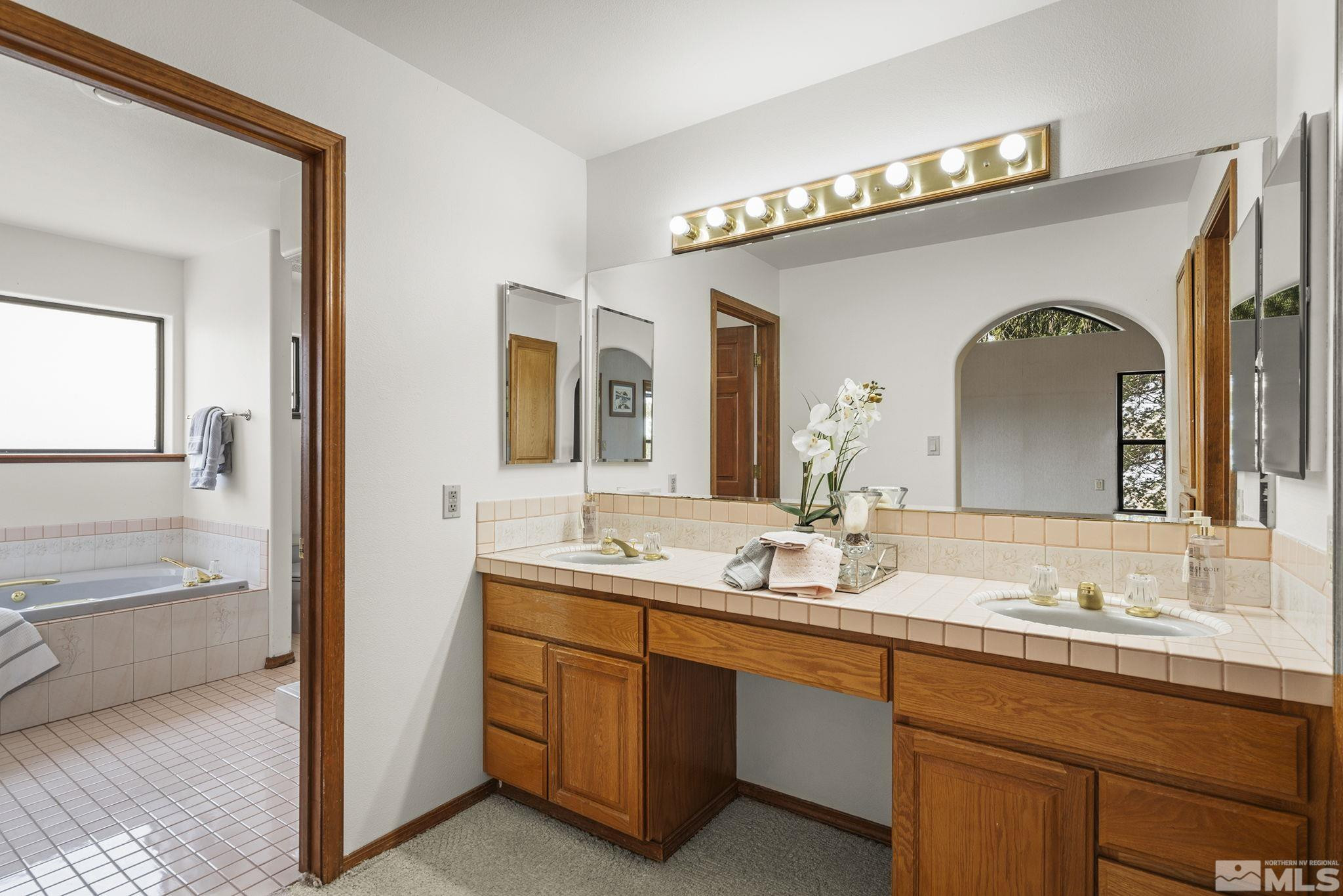 80 Cassas Court Reno, NV 89511 - Photo 21 of 40 a bathroom with a granite countertop sink vanity and mirror