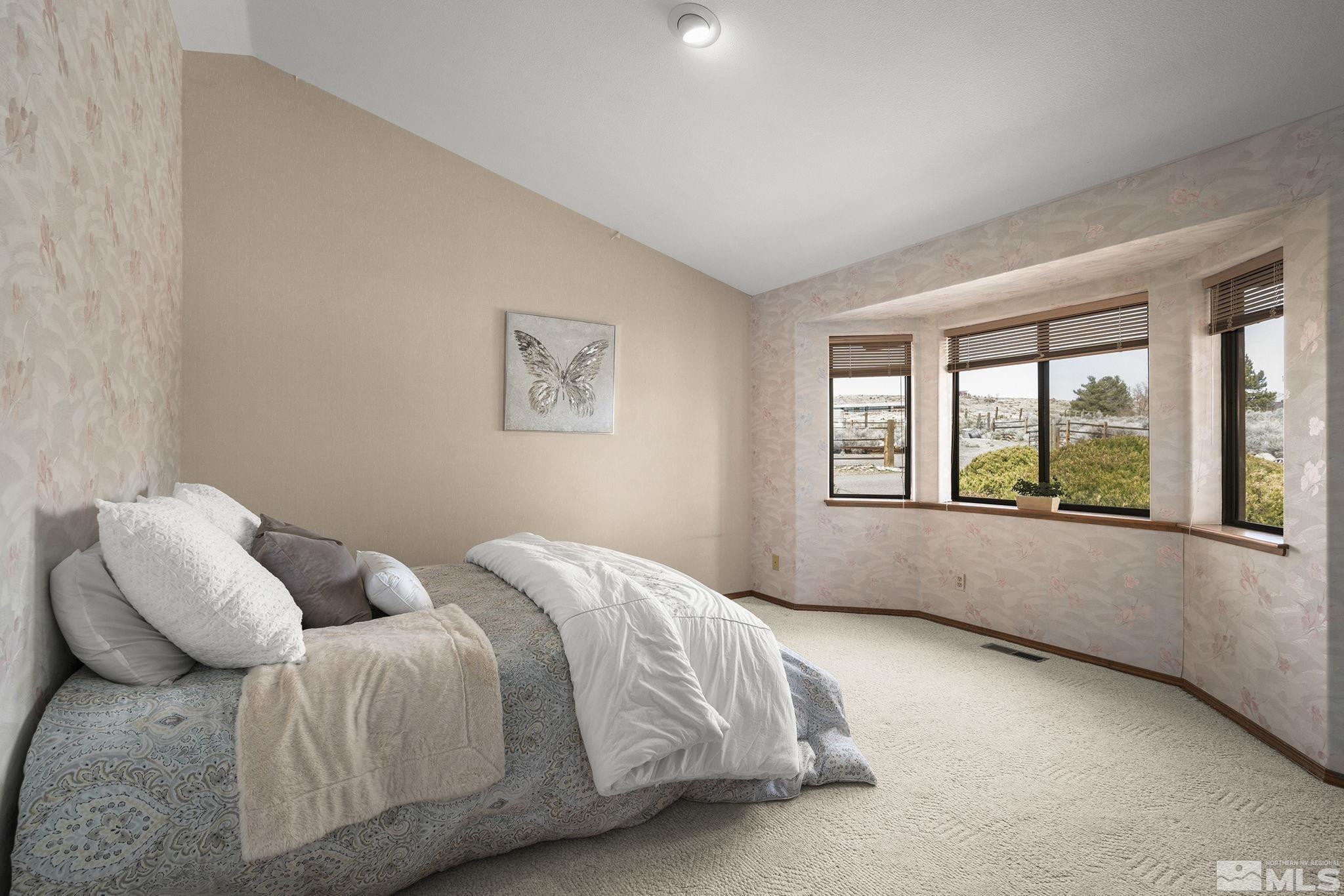 80 Cassas Court Reno, NV 89511 - Photo 22 of 40 a bedroom with a bed and a large window