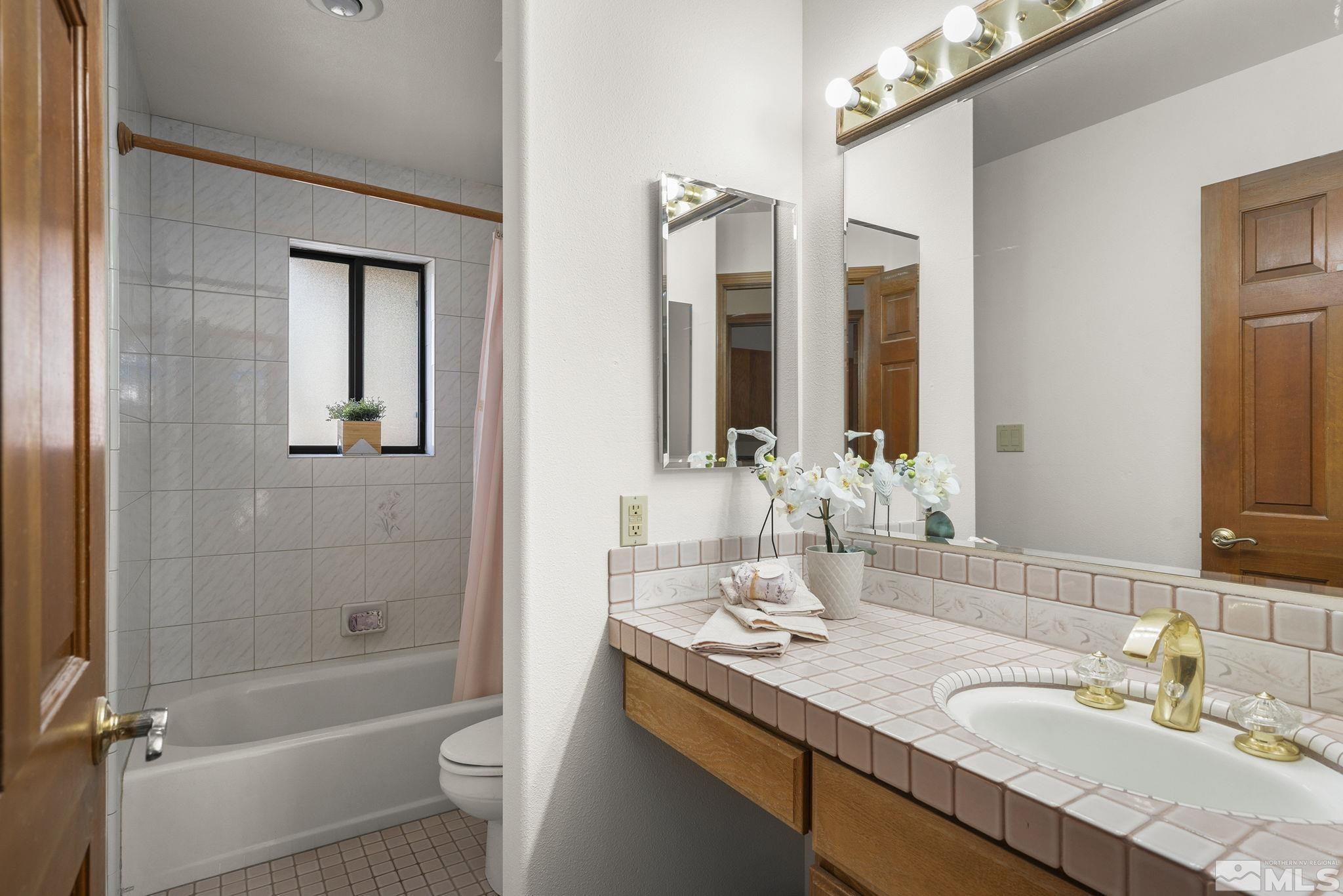 80 Cassas Court Reno, NV 89511 - Photo 23 of 40 a bathroom with a granite countertop sink toilet and shower