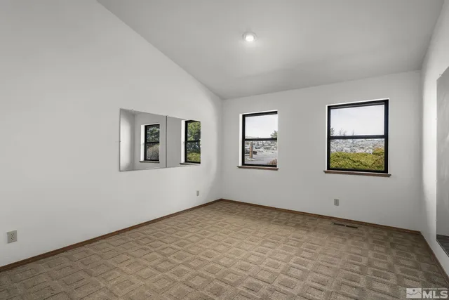 a view of a balcony with chairs and wooden floor