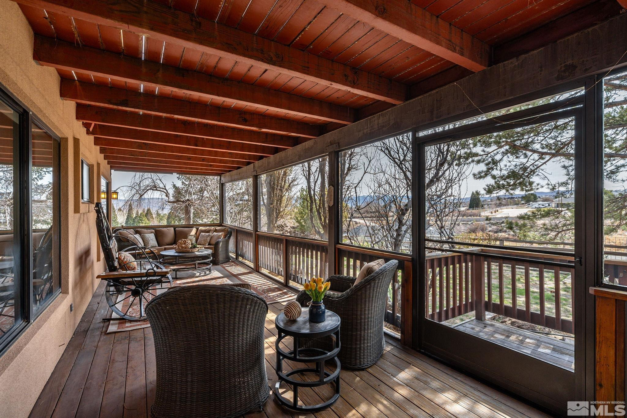 80 Cassas Court Reno, NV 89511 - Photo 27 of 40 a view of a balcony with chairs and wooden floor