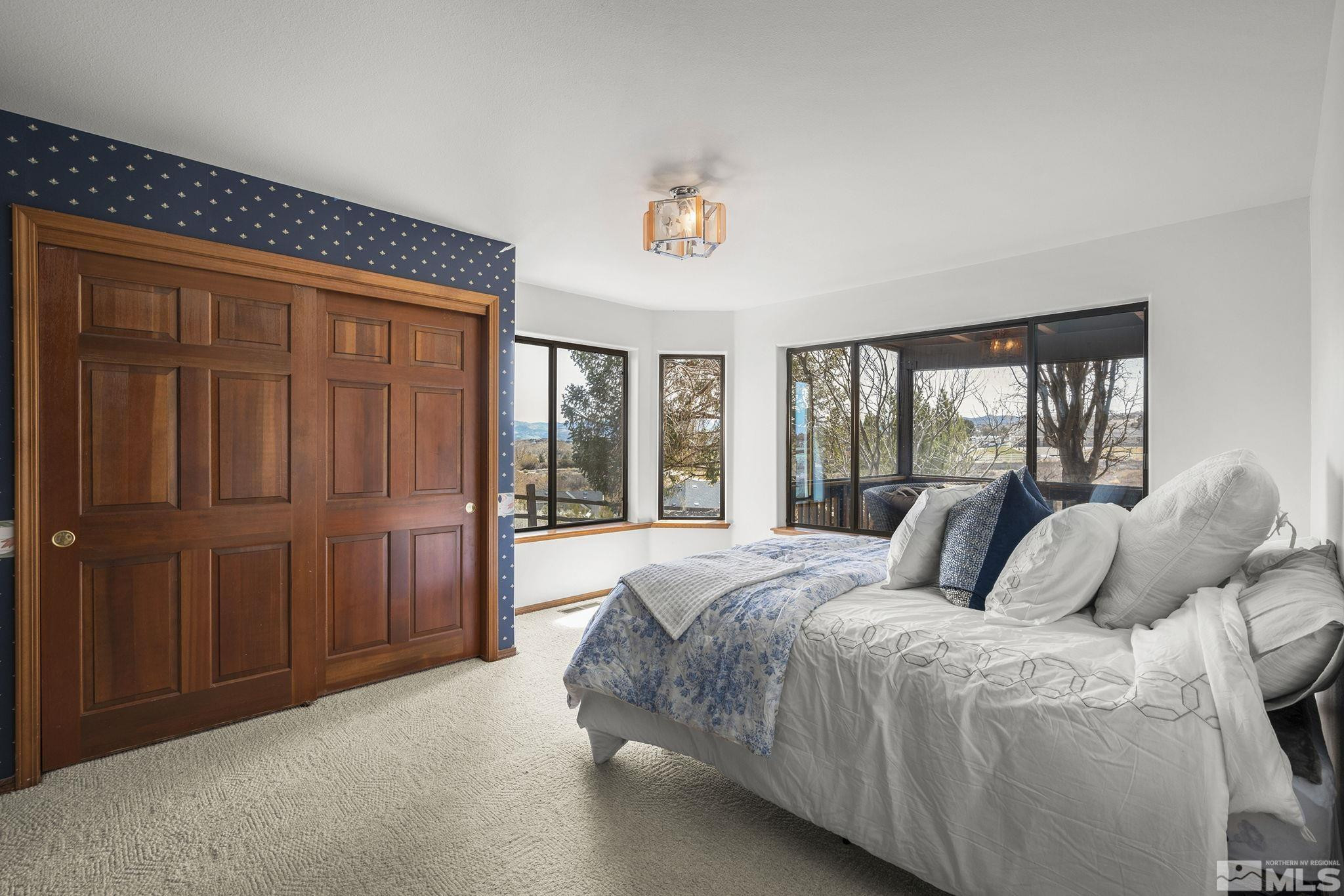 80 Cassas Court Reno, NV 89511 - Photo 29 of 40 a bedroom with a large bed and a window