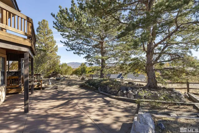 a backyard of a house with table and chairs
