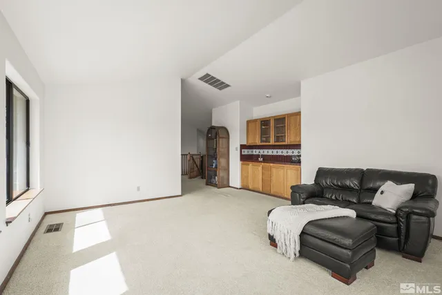 a kitchen with stainless steel appliances granite countertop a sink refrigerator and cabinets