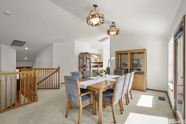 a kitchen with kitchen island granite countertop a sink and a refrigerator