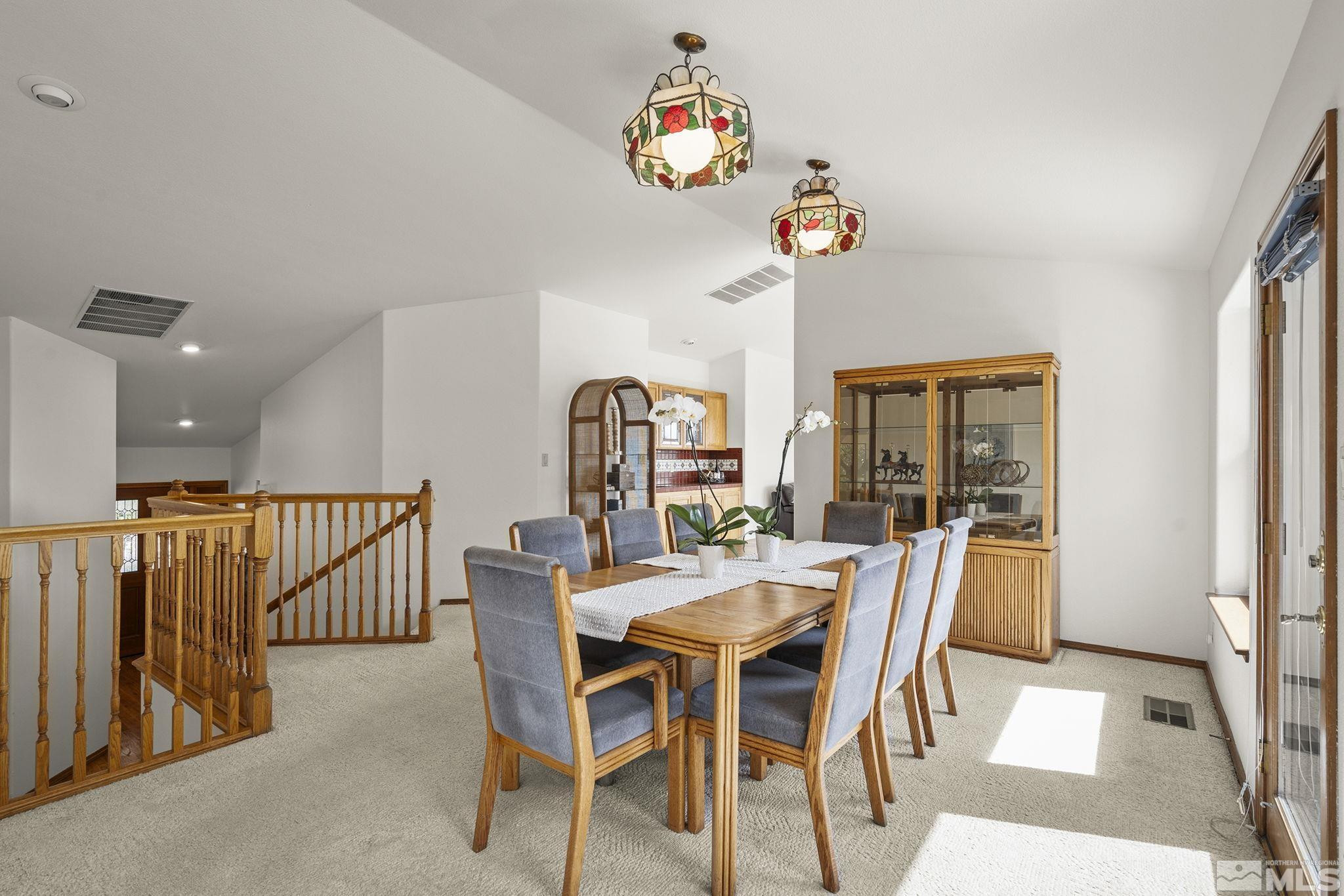 80 Cassas Court Reno, NV 89511 - Photo 10 of 40 a dining room with furniture a rug and a chandelier