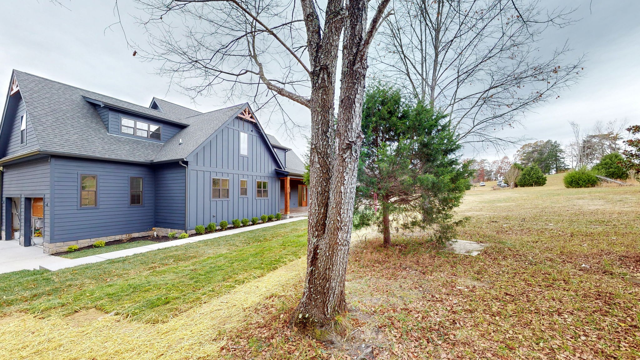 1636 Deal Road Burns, TN 37029 - Photo 5 of 10 a front view of a house with a yard and garage