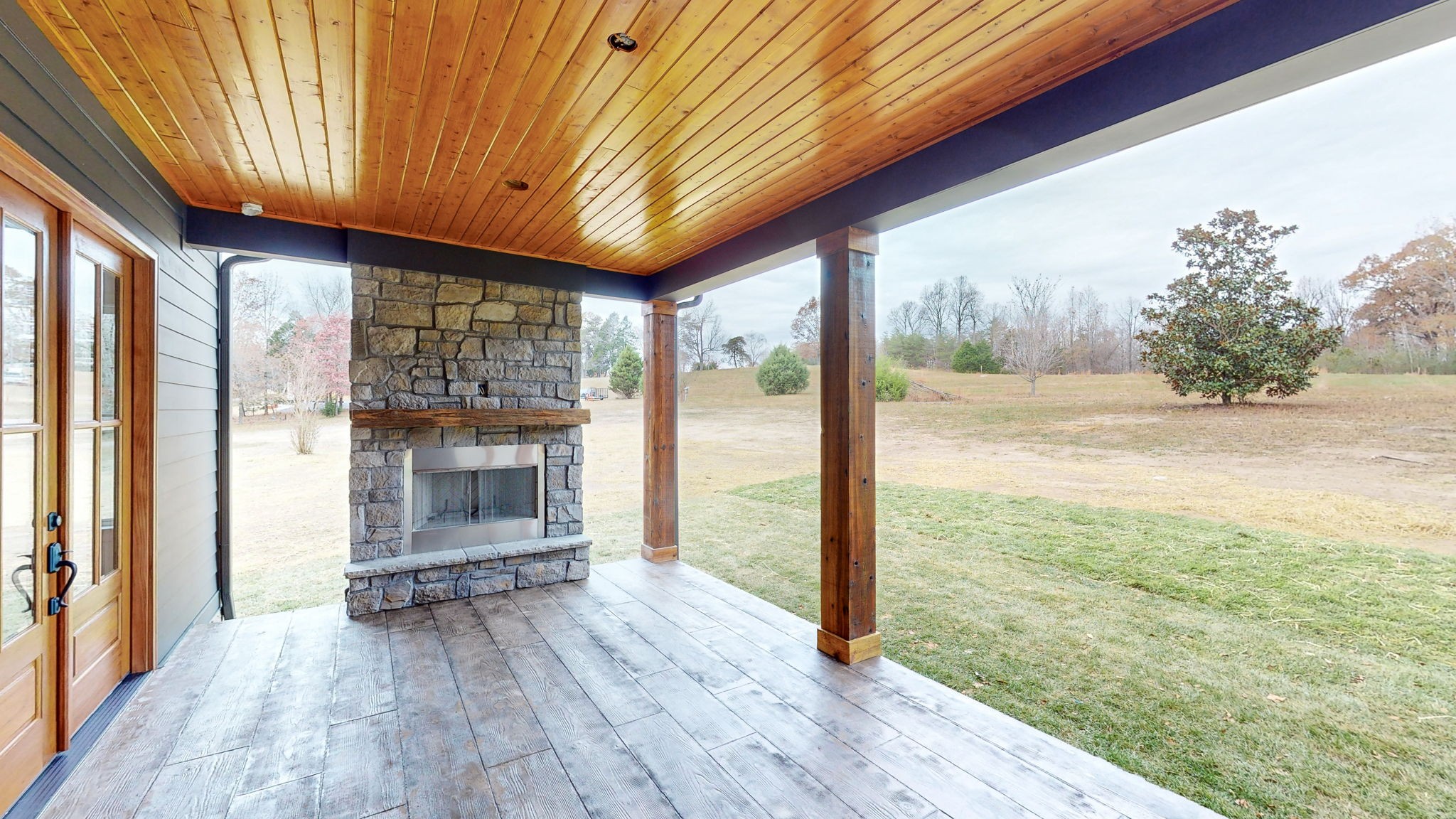 1636 Deal Road Burns, TN 37029 - Photo 8 of 10 a view of livingroom with floor to ceiling window wooden floor and brick wall