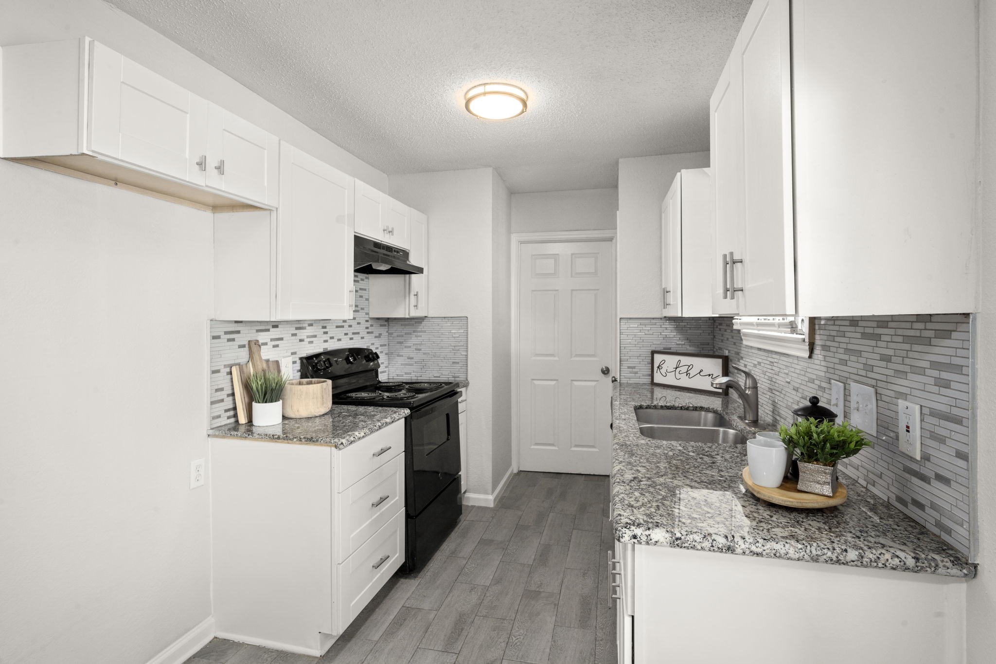 5219 Myrtlewood Street Houston, TX 77033 - Photo 16 of 36 a kitchen with stainless steel appliances granite countertop sink stove and cabinets