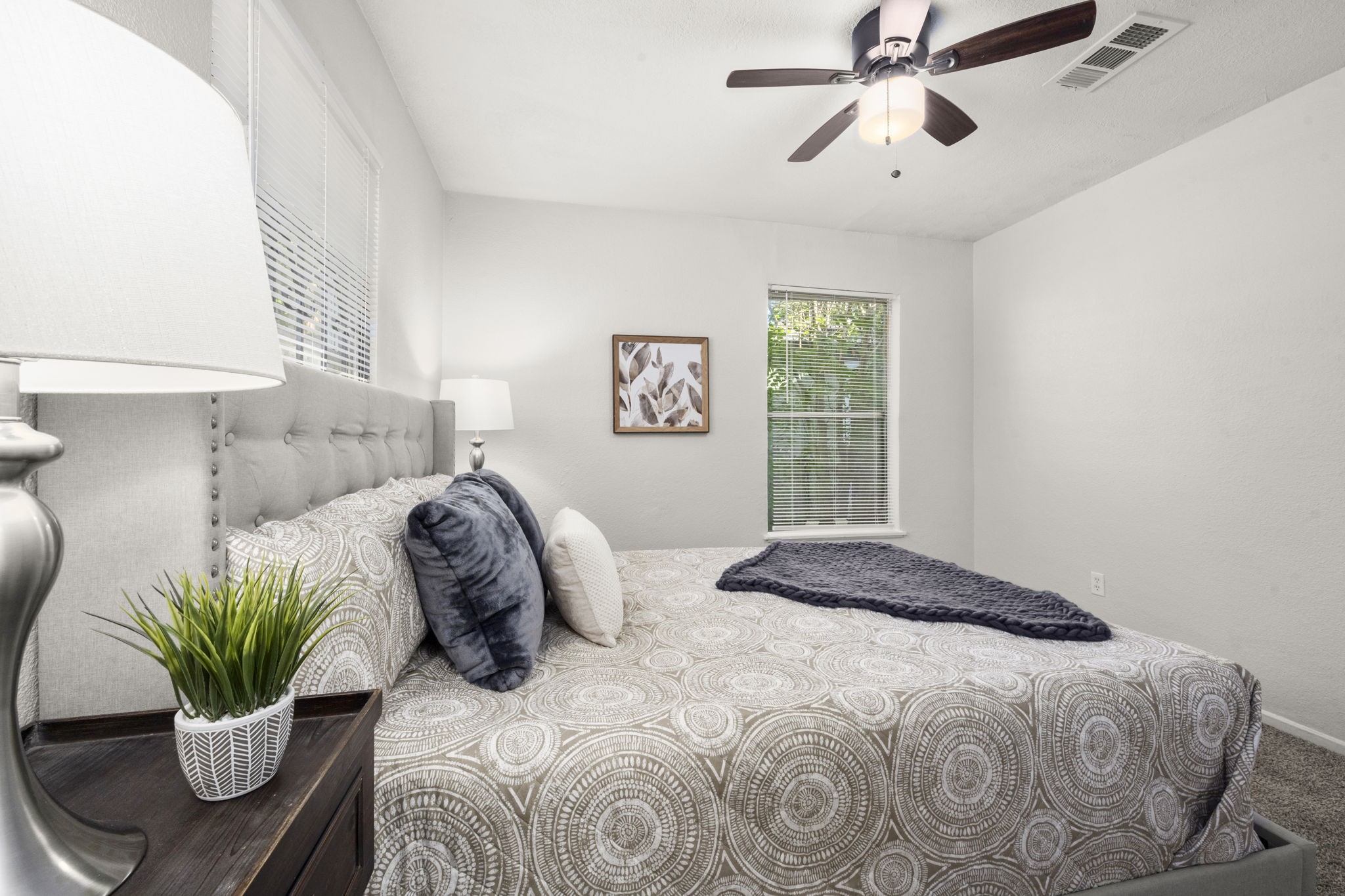 5219 Myrtlewood Street Houston, TX 77033 - Photo 23 of 36 a bedroom with a bed and a potted plant