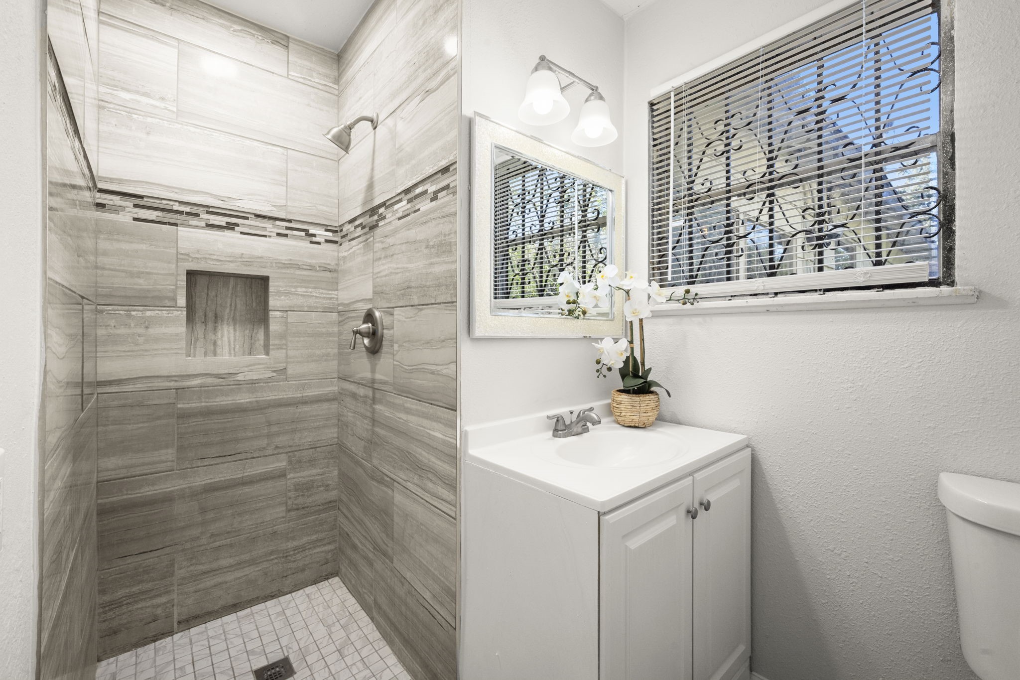5219 Myrtlewood Street Houston, TX 77033 - Photo 24 of 36 a bathroom with a sink a toilet and shower