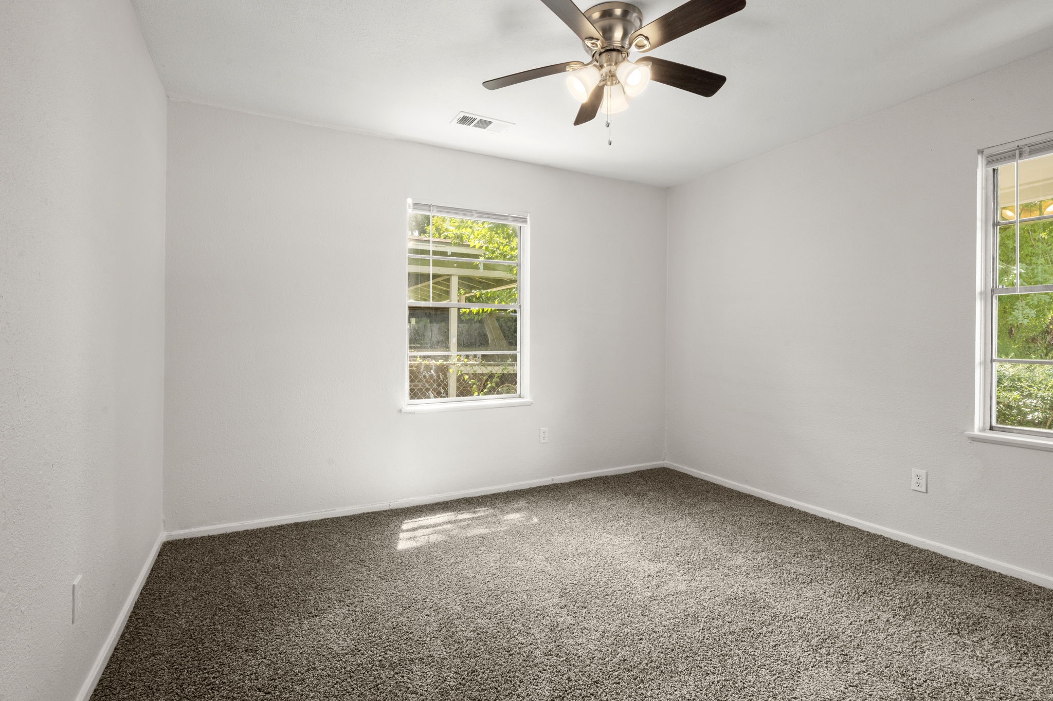 5219 Myrtlewood Street Houston, TX 77033 - Photo 26 of 36 an empty room with a window and a fan