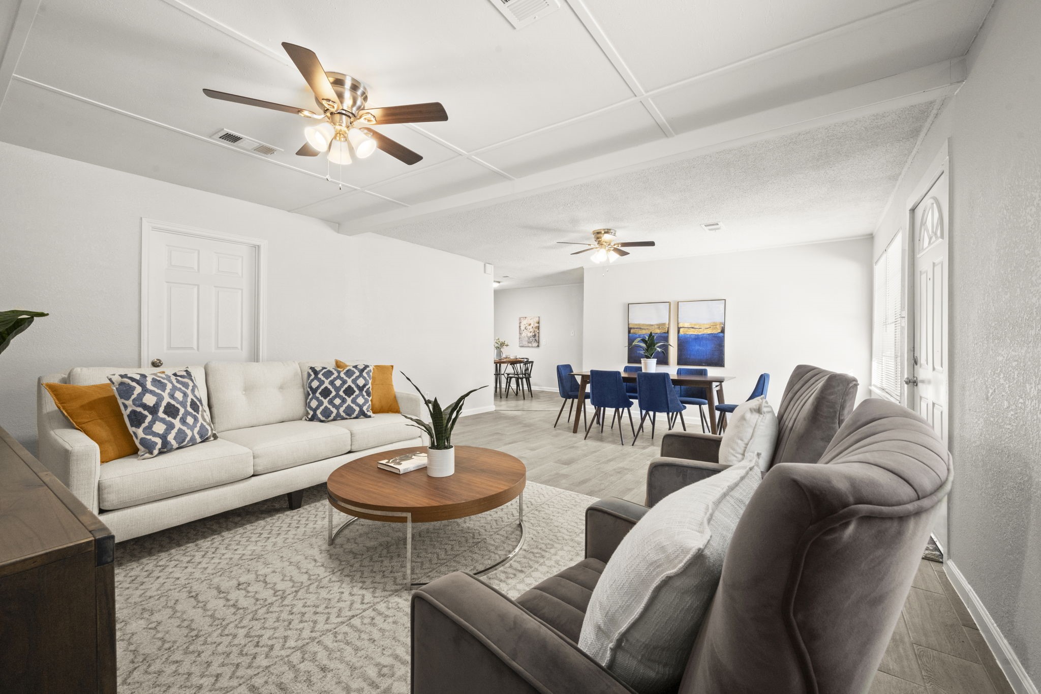5219 Myrtlewood Street Houston, TX 77033 - Photo 8 of 36 a living room with furniture a rug and a chandelier
