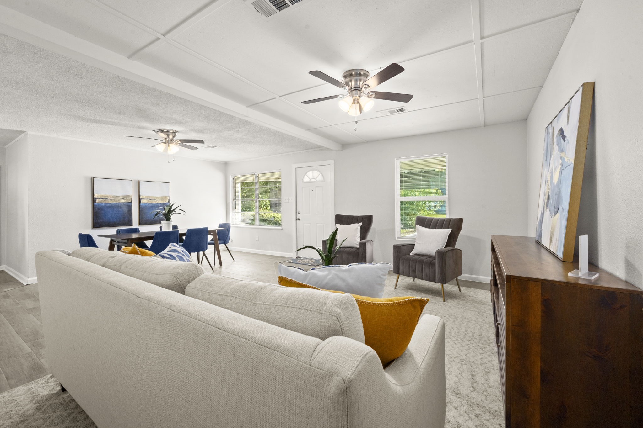 5219 Myrtlewood Street Houston, TX 77033 - Photo 10 of 36 a living room with furniture a large window and a chandelier